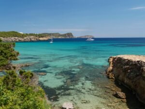 Explore the turquoise waters and stunning coastline of Cala Nova in Ibiza, Spain.